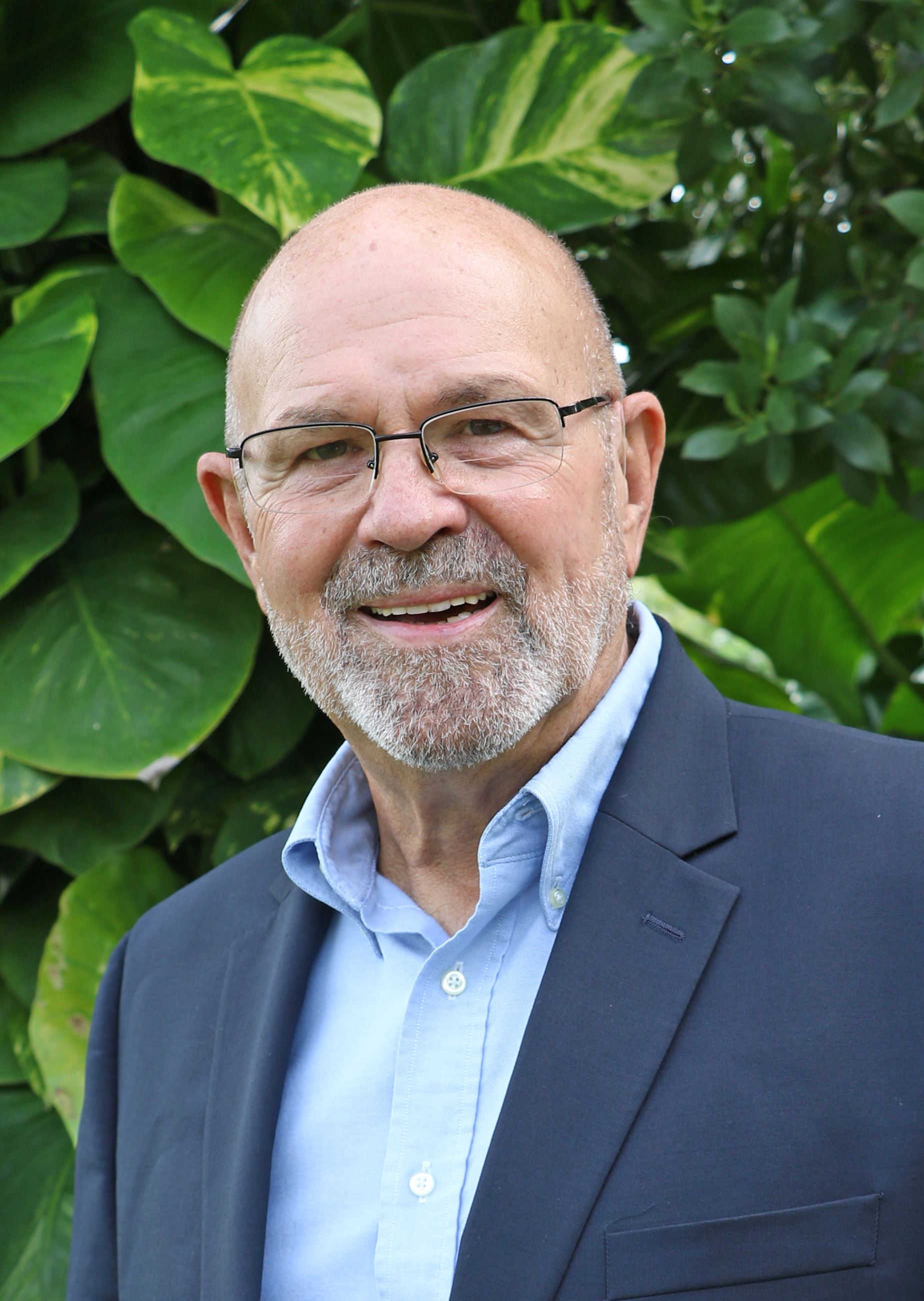 David Rice Headshot in front of green leaves
